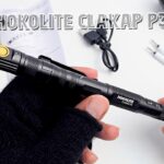 A close-up of the HOKOLITE CLAKAP P3 7-in-1 Pen light showing its machined aluminum body and pen tip.