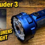 A person holding the large Olight Marauder 3 flashlight, highlighting the side toggle and front-facing lens.